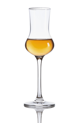 Grappa glass filled with grappa.